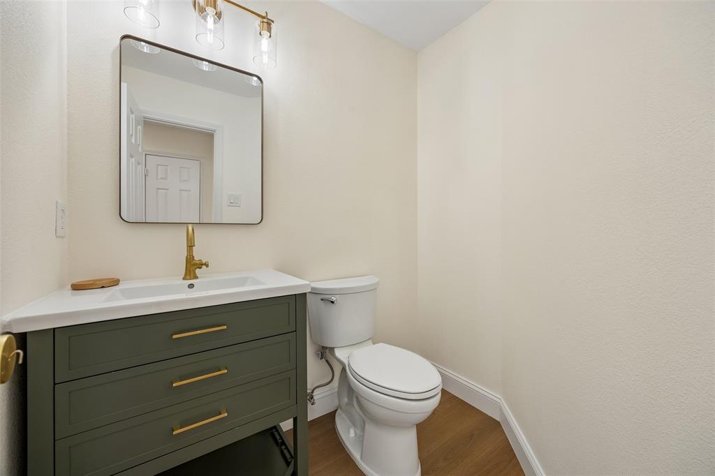 819 Kipling Drive Allen, TX 75002 - Photo 27 of 29 a bathroom with a toilet sink vanity and mirror
