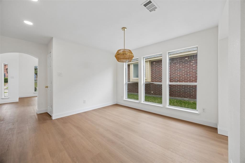 819 Kipling Drive Allen, TX 75002 - Photo 9 of 29 a view of an empty room with a window and wooden floor