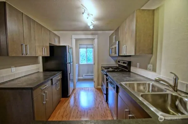 a kitchen with a sink stove and refrigerator