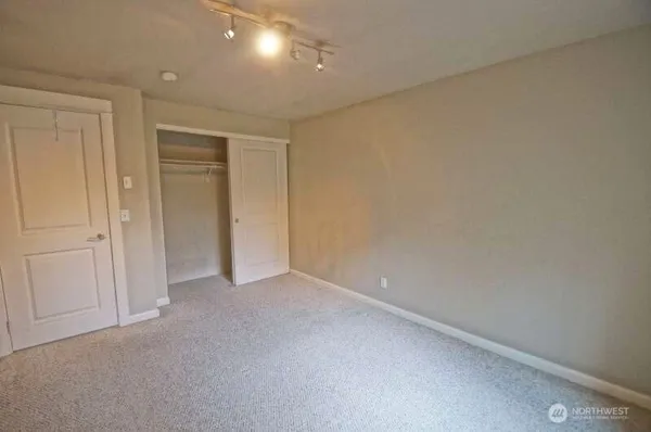 an empty room with a empty space and a ceiling fan