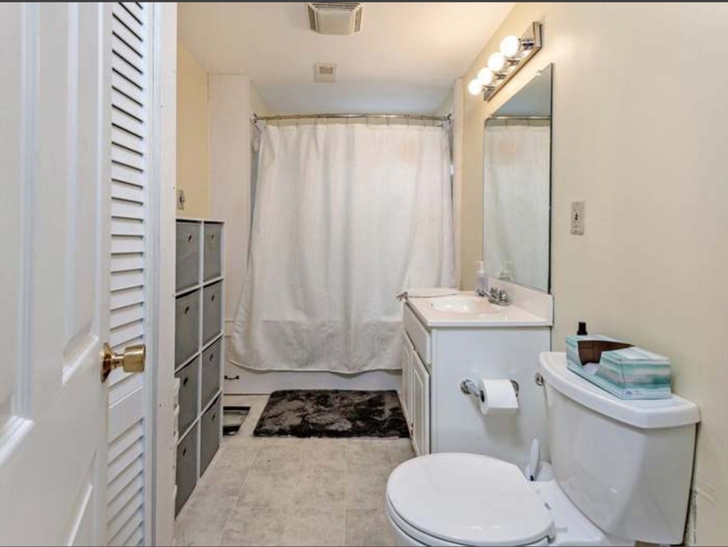 3 Orchard Street, Unit B Millbury, MA 01527 - Photo 11 of 17 a bathroom with a sink a toilet a mirror and shower