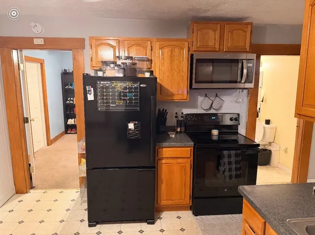 a kitchen with stainless steel appliances granite countertop a refrigerator and a stove