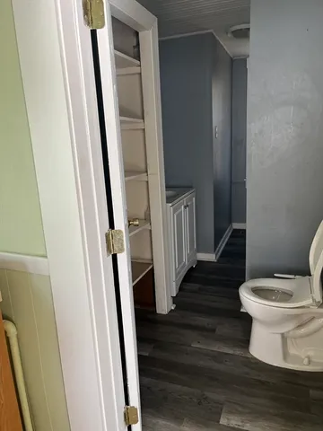 a white toilet sitting next to a sink