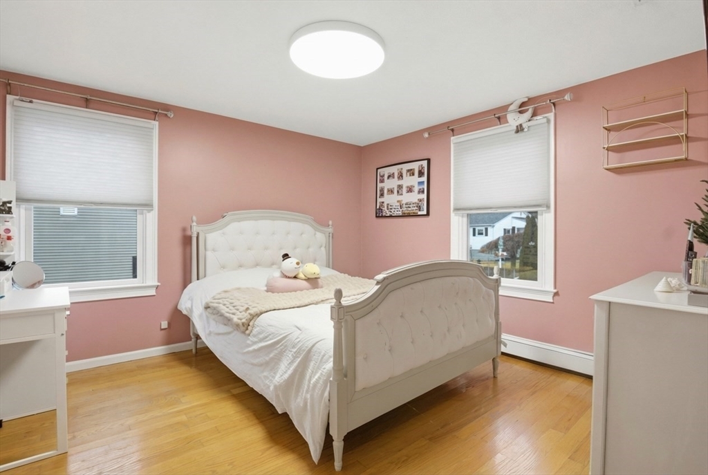 64 Browning Road Arlington, MA 02476 - Photo 13 of 25 a bedroom with a bed and a window