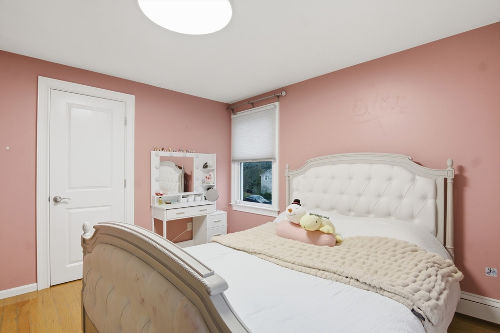 64 Browning Road Arlington, MA 02476 - Photo 14 of 25 a bedroom with a bed and a couch