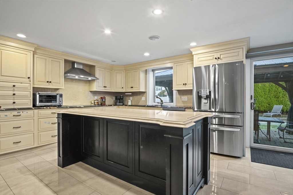 64 Browning Road Arlington, MA 02476 - Photo 2 of 25 a kitchen with stainless steel appliances granite countertop a refrigerator and a stove top oven
