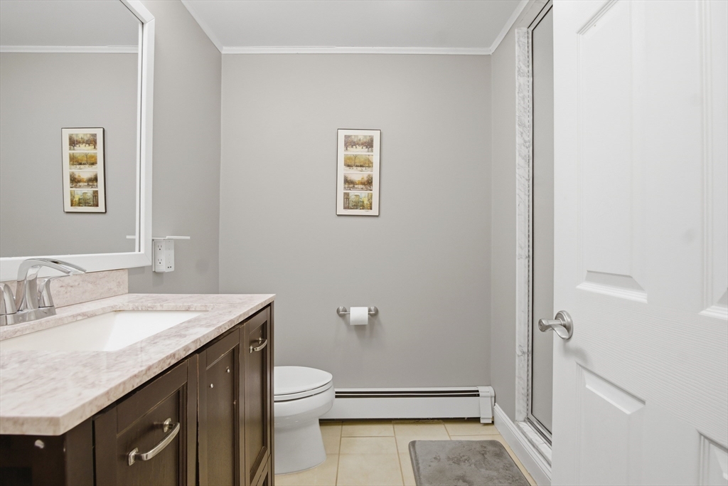 64 Browning Road Arlington, MA 02476 - Photo 21 of 25 a bathroom with a granite countertop sink toilet and shower