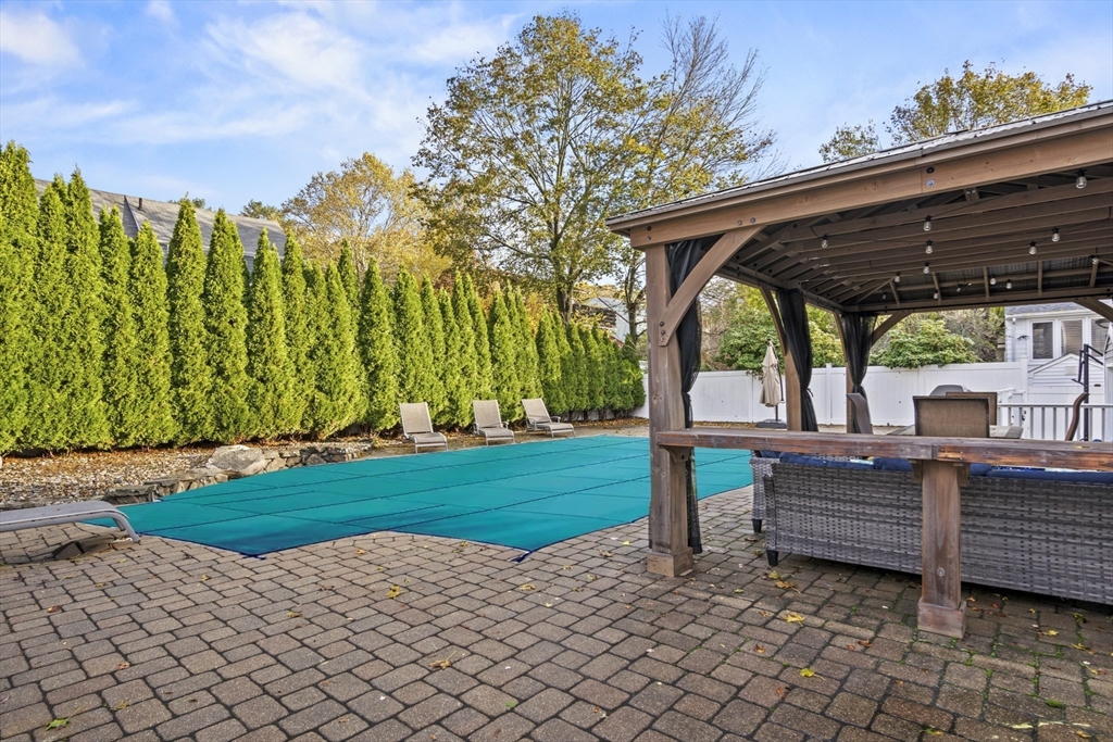 64 Browning Road Arlington, MA 02476 - Photo 23 of 25 a view of a patio with table and chairs with wooden fence
