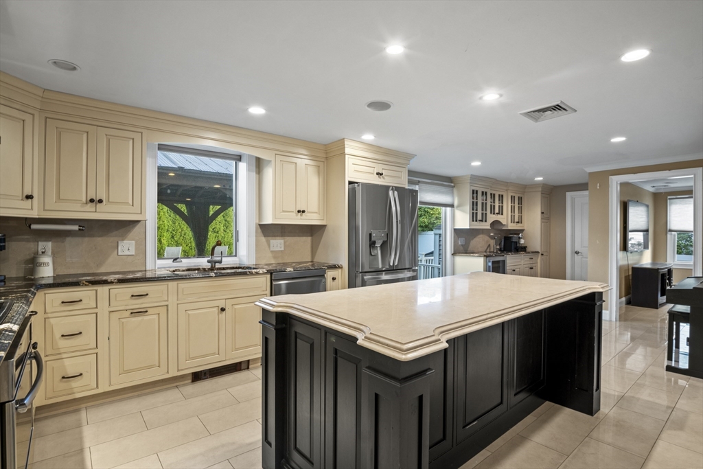64 Browning Road Arlington, MA 02476 - Photo 3 of 25 a kitchen with a stove sink and cabinets