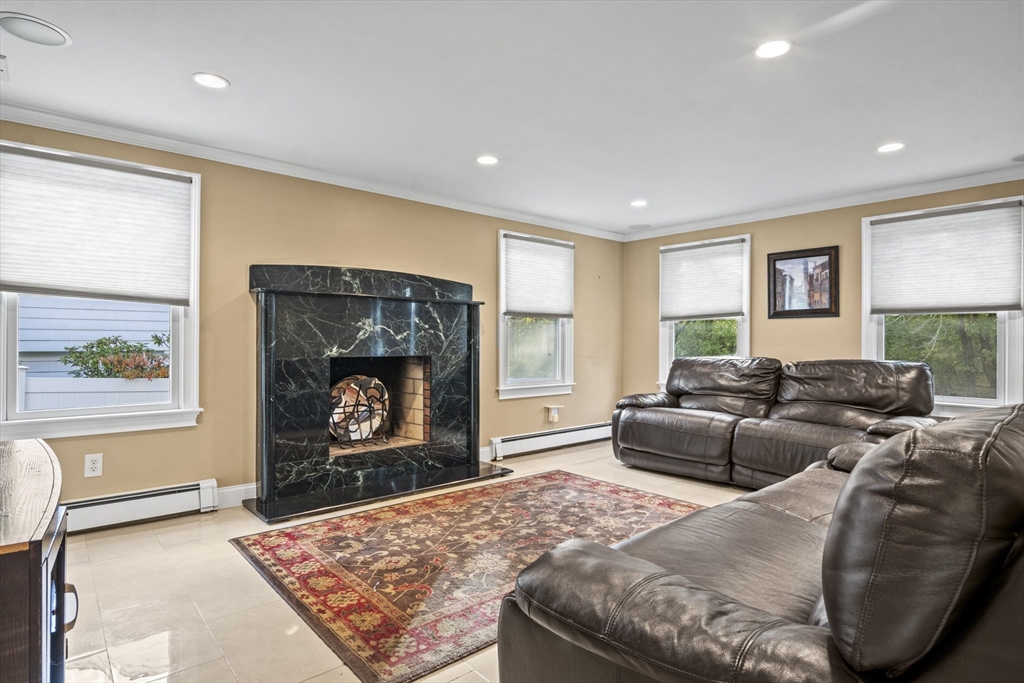 64 Browning Road Arlington, MA 02476 - Photo 8 of 25 a living room with furniture a fireplace and a flat screen tv