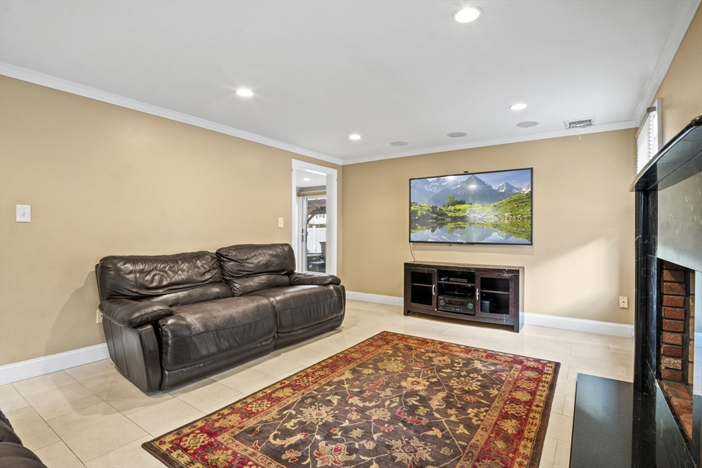 64 Browning Road Arlington, MA 02476 - Photo 9 of 25 a living room with furniture and a flat screen tv