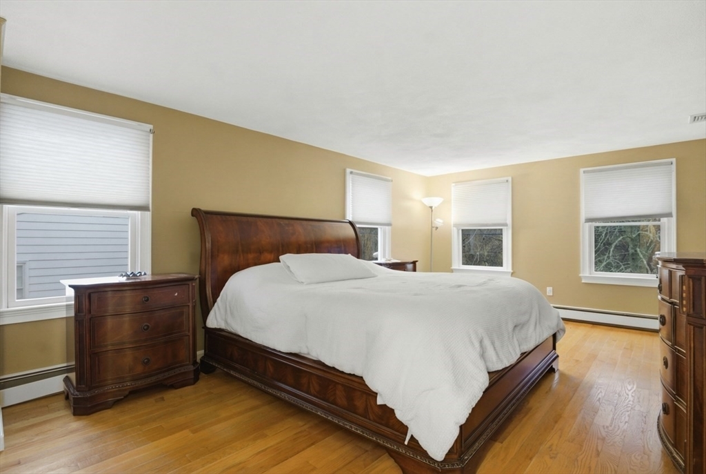 64 Browning Road Arlington, MA 02476 - Photo 10 of 25 a large bed sitting in a bedroom next to a window