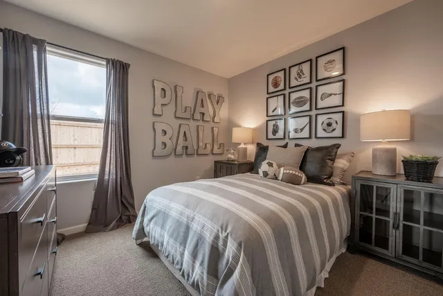 a bedroom with a large bed and a window