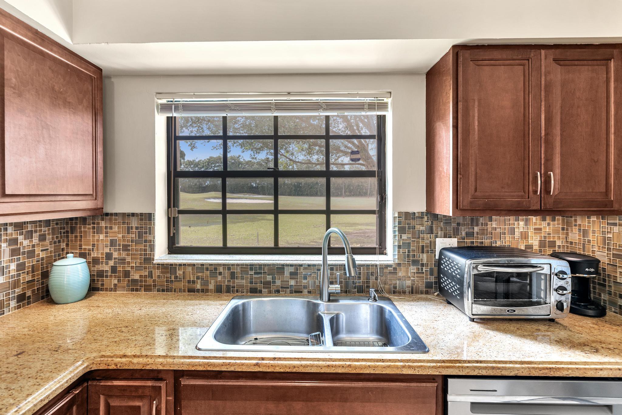 17372 Boca Club Boulevard, Unit 405 Boca Raton, FL 33487 - Photo 30 of 74 a kitchen with a sink and a counter top space