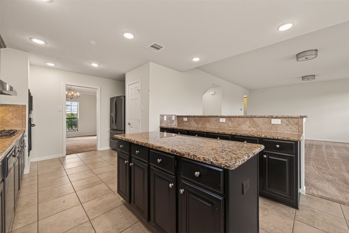 29 Palmero Way Manvel, TX 77578 - Photo 11 of 31 a kitchen with a stove a sink and a refrigerator