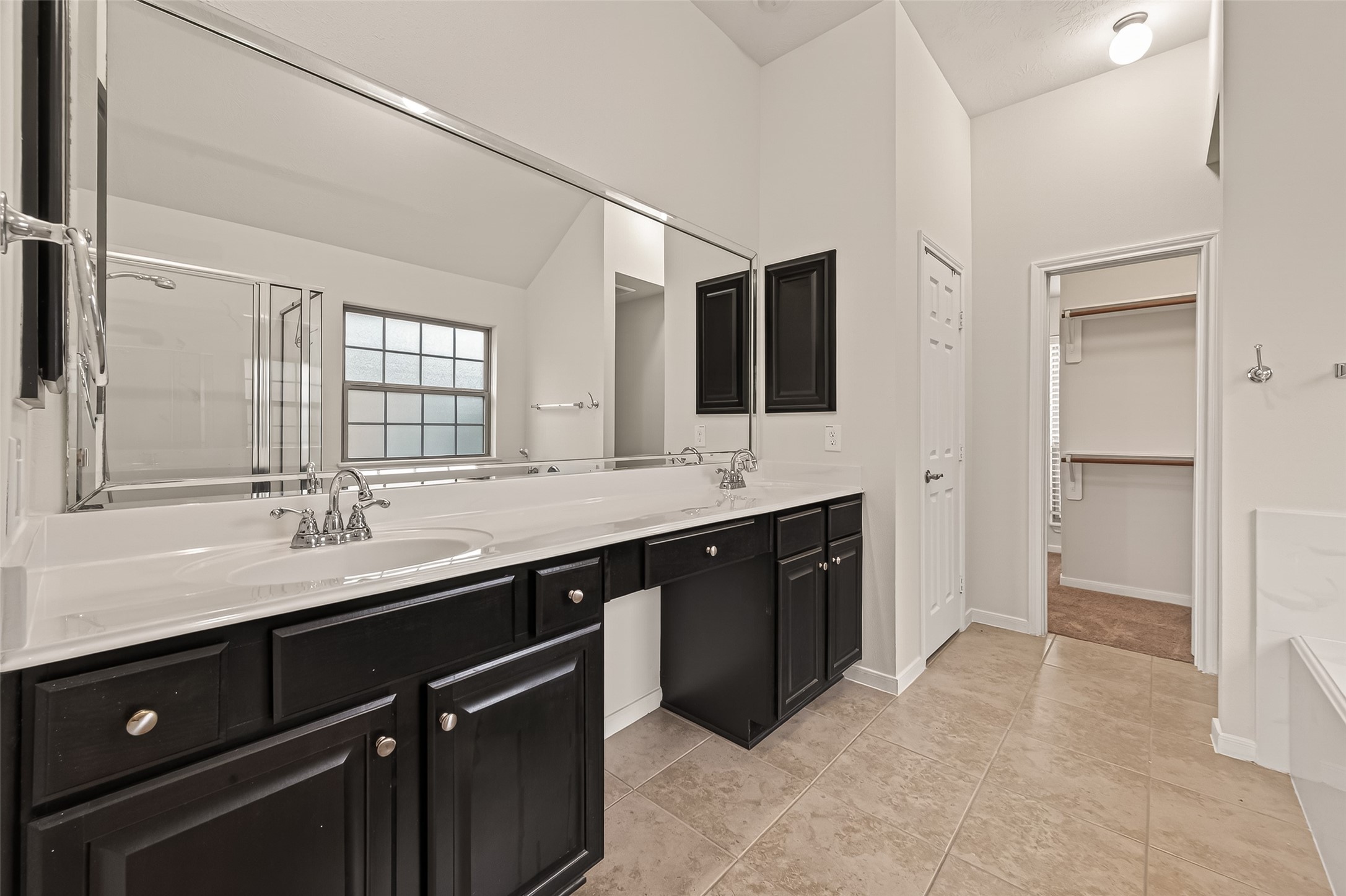 29 Palmero Way Manvel, TX 77578 - Photo 14 of 31 Primary ensuite bathroom with dual vanities, large walk-in closet, and plenty of space for everyday comfort.