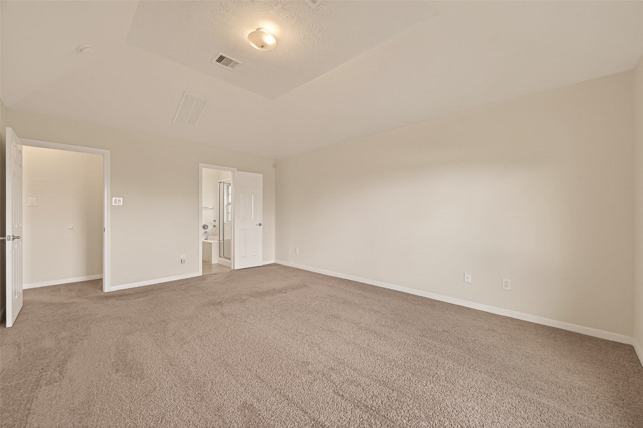29 Palmero Way Manvel, TX 77578 - Photo 16 of 31 Alternate view of the primary bedroom highlighting its size and direct access to the ensuite bathroom.