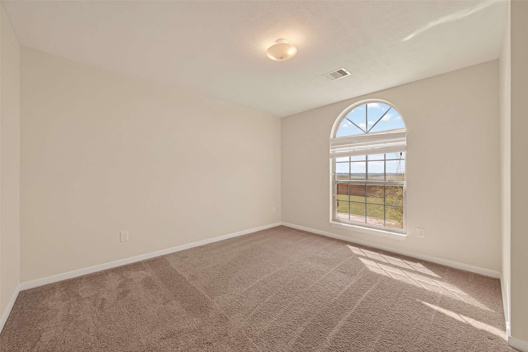 29 Palmero Way Manvel, TX 77578 - Photo 24 of 31 Secondary bedroom with arched window allowing for abundant natural light.