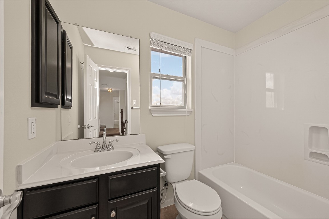 29 Palmero Way Manvel, TX 77578 - Photo 27 of 31 a bathroom with a sink toilet a mirror and shower