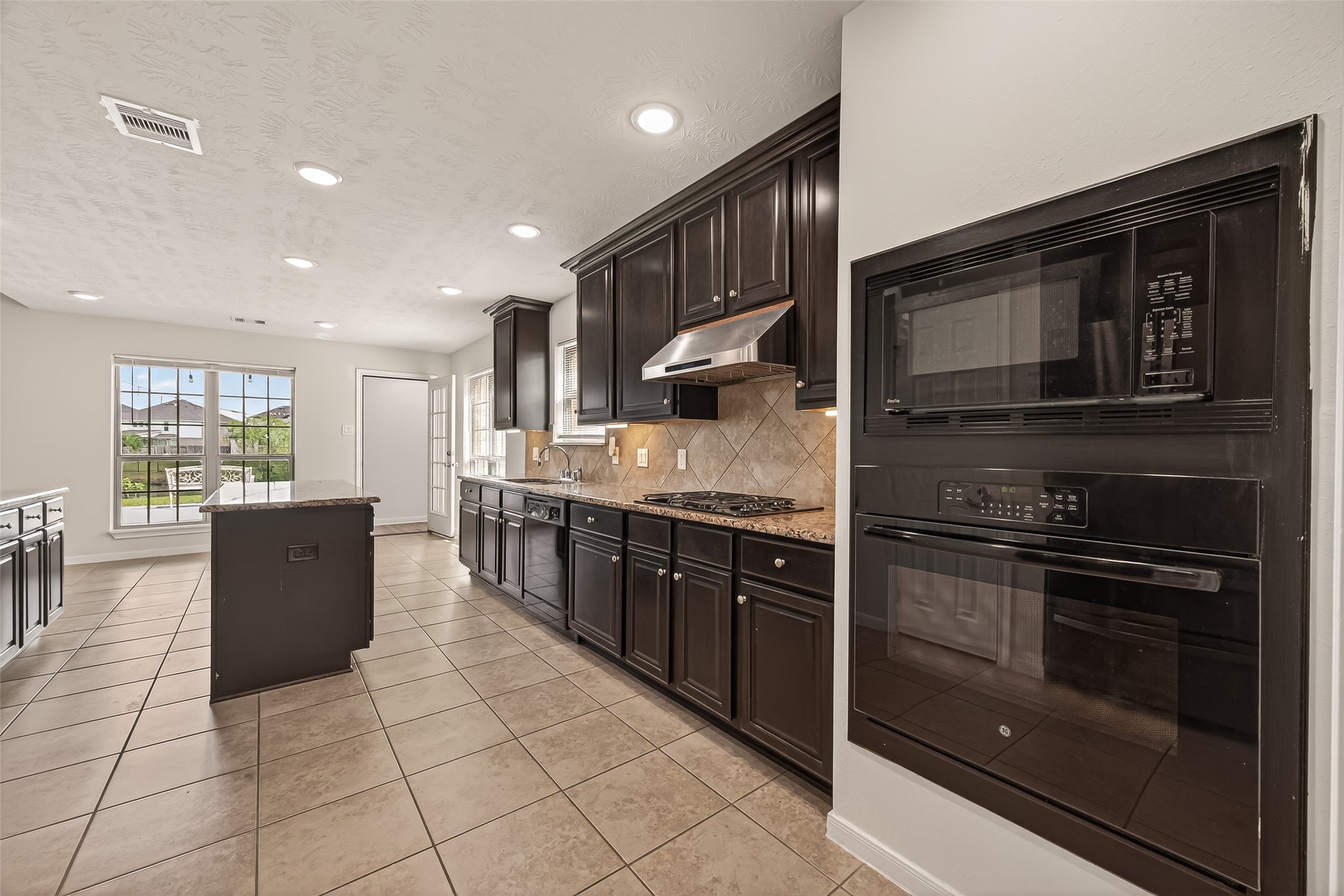 29 Palmero Way Manvel, TX 77578 - Photo 4 of 31 Kitchen with granite countertops, abundant cabinetry, and a large island ideal for entertaining.