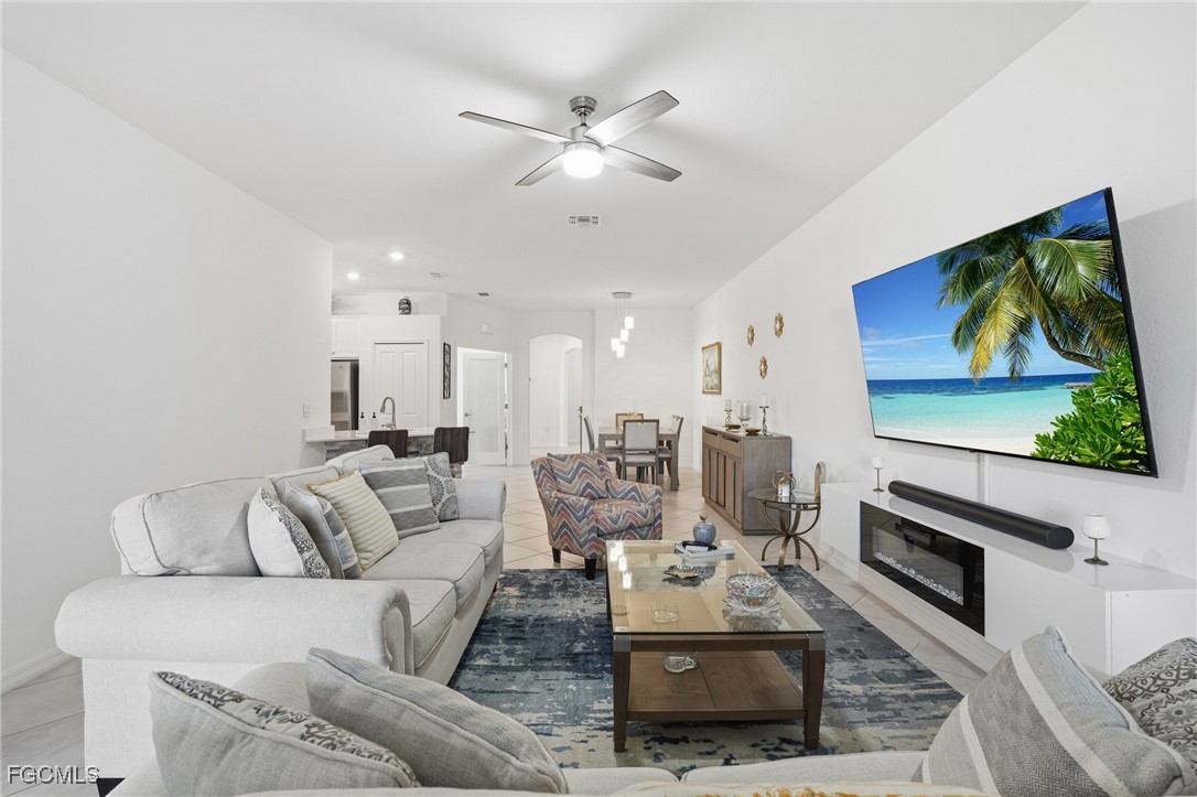 2617 Vine Avenue Naples, FL 34120 - Photo 13 of 27 a living room with furniture and a flat screen tv