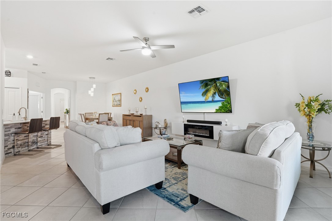 2617 Vine Avenue Naples, FL 34120 - Photo 14 of 27 a living room with furniture and a flat screen tv