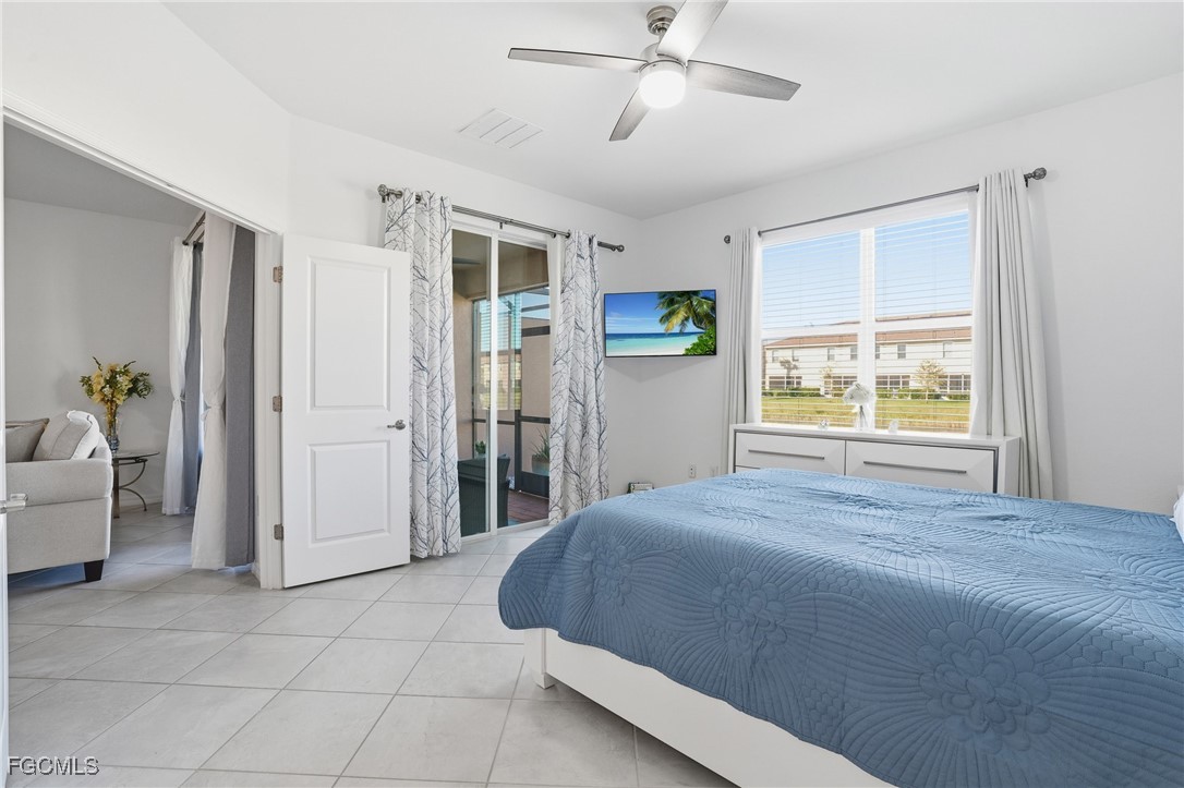 2617 Vine Avenue Naples, FL 34120 - Photo 17 of 27 a spacious bedroom with a large bed and a window
