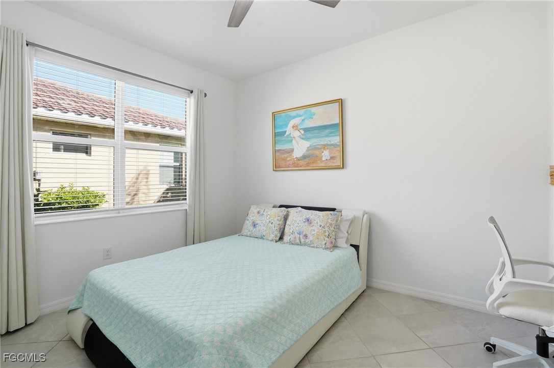 2617 Vine Avenue Naples, FL 34120 - Photo 21 of 27 a bedroom with a bed and a window
