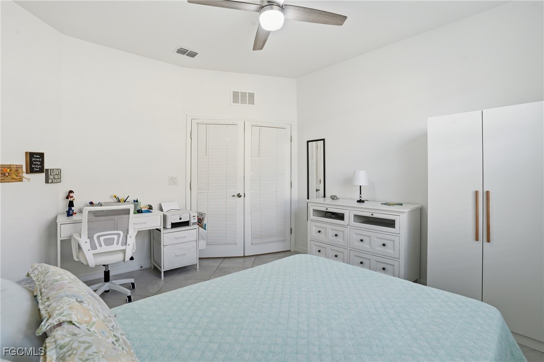 2617 Vine Avenue Naples, FL 34120 - Photo 22 of 27 a bedroom with a bed and furniture