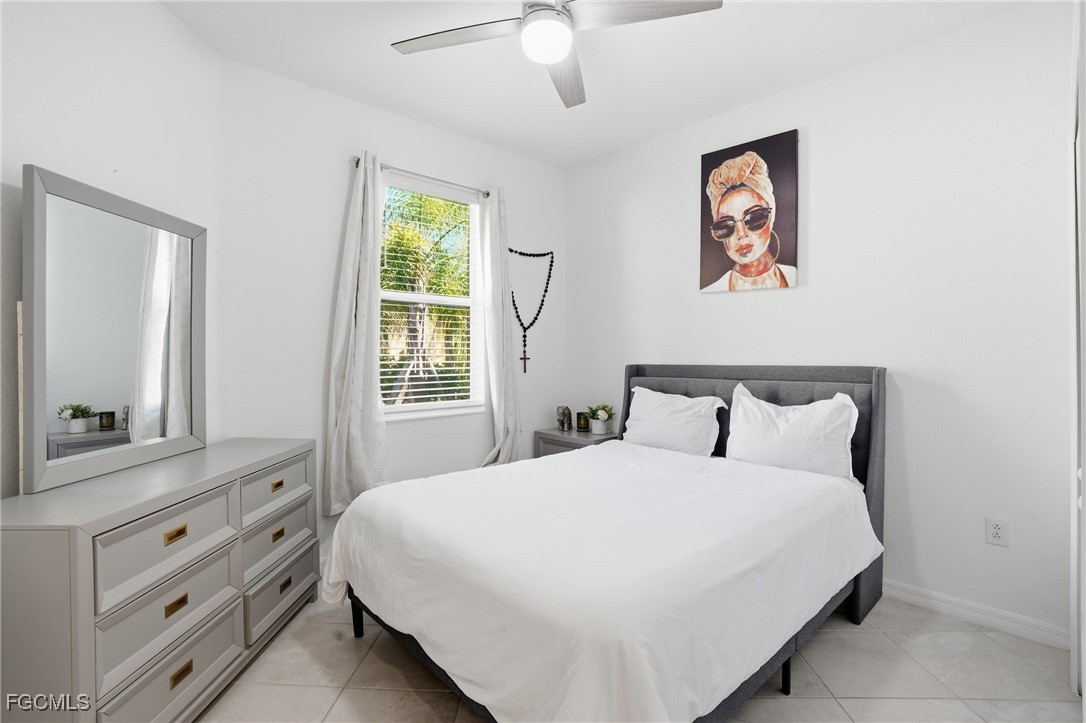 2617 Vine Avenue Naples, FL 34120 - Photo 23 of 27 a bedroom with a large bed and a window