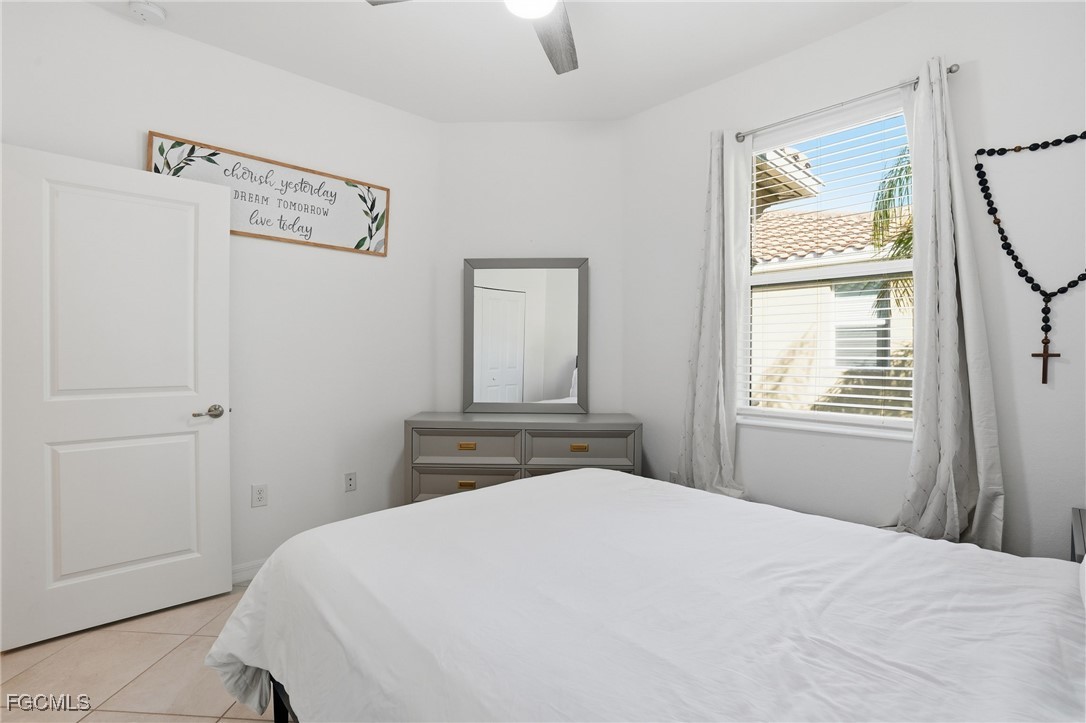2617 Vine Avenue Naples, FL 34120 - Photo 25 of 27 a bedroom with a bed and a window