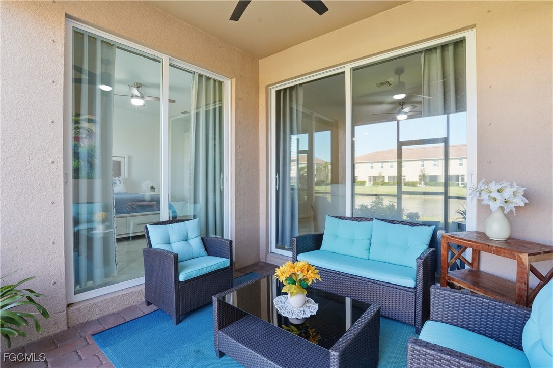 2617 Vine Avenue Naples, FL 34120 - Photo 26 of 27 a living room with furniture and a large window with garden view