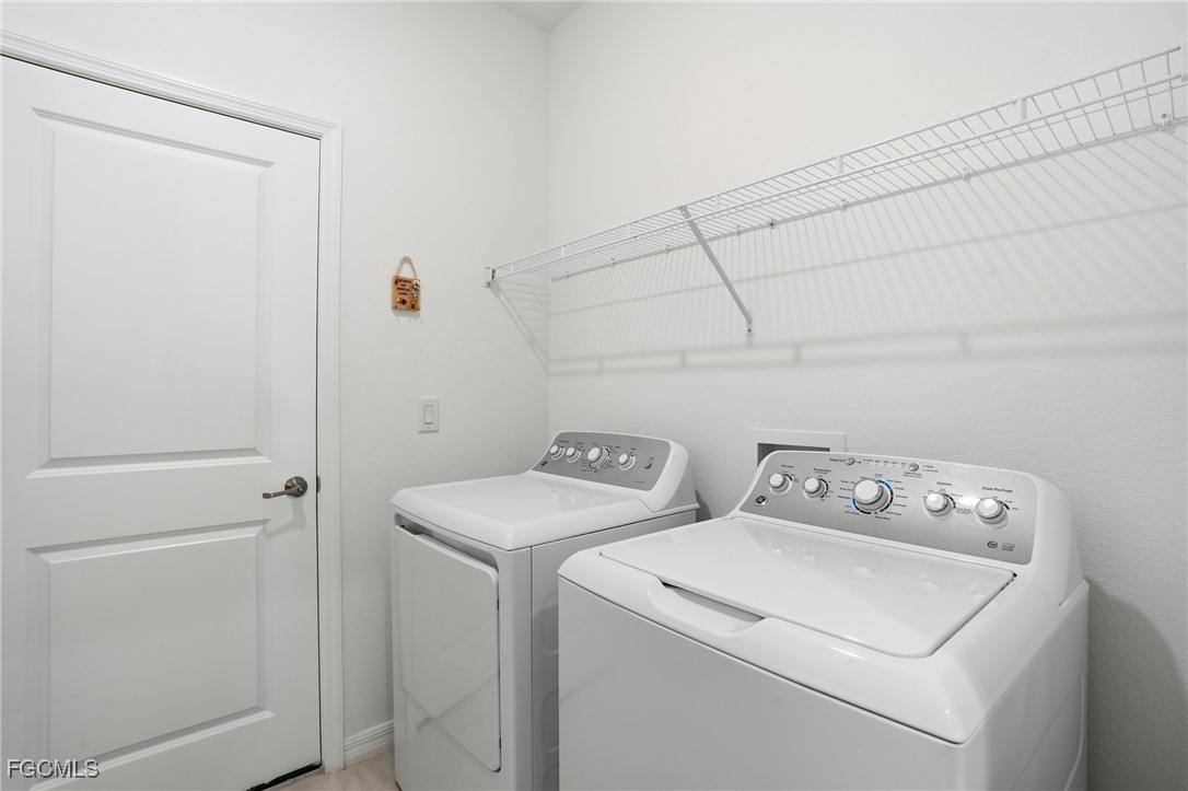 2617 Vine Avenue Naples, FL 34120 - Photo 27 of 27 a utility room with dryer and washer