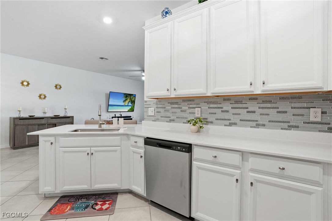 2617 Vine Avenue Naples, FL 34120 - Photo 6 of 27 a kitchen with white cabinets and sink
