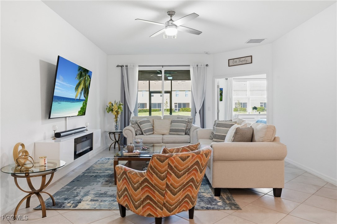 2617 Vine Avenue Naples, FL 34120 - Photo 10 of 27 a living room with furniture and a flat screen tv