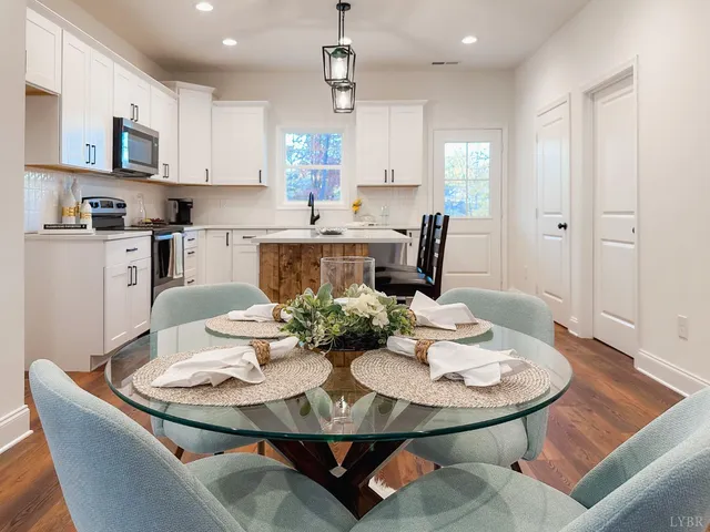 a kitchen with stainless steel appliances a stove a sink a microwave a center island and cabinets