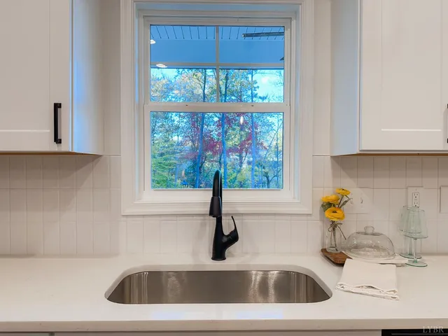 a kitchen with a sink a stove and cabinets