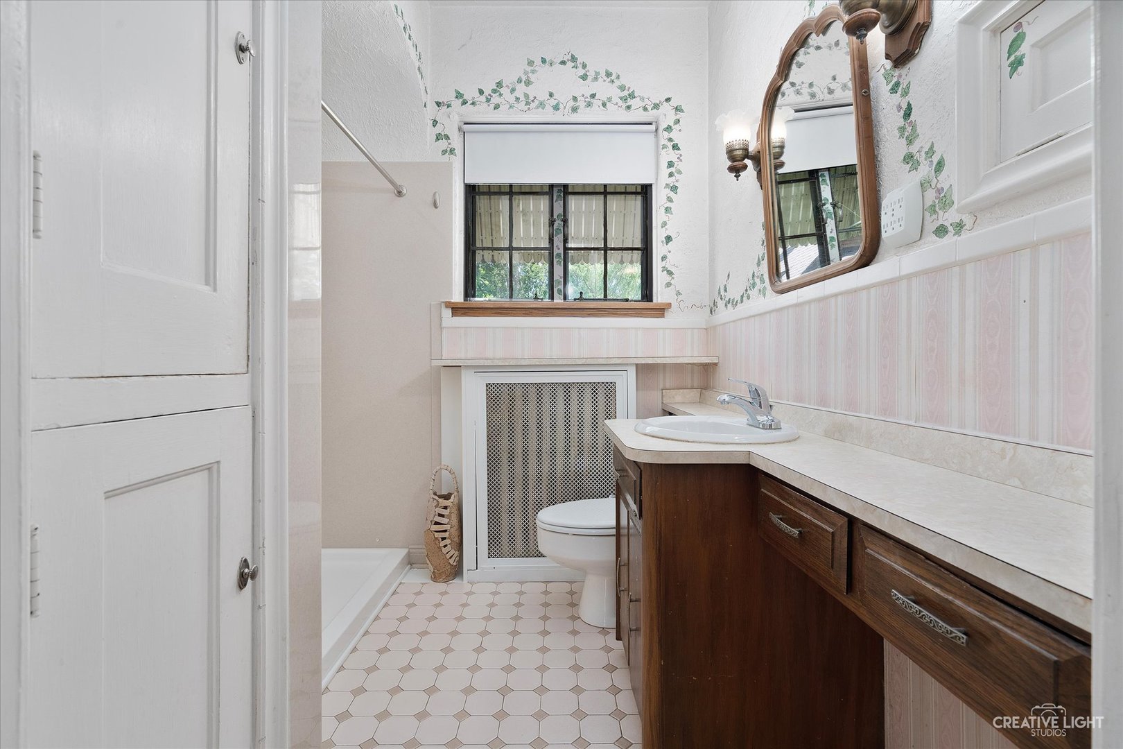 1125 Cedar Avenue Elgin, IL 60120 - Photo 15 of 29 a bathroom with a sink a toilet and a mirror