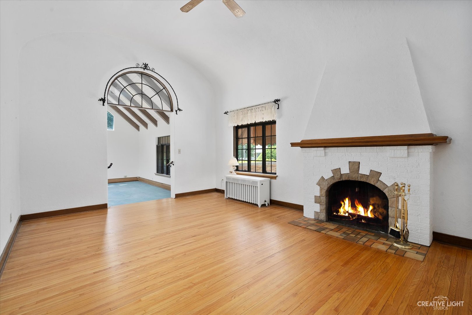 1125 Cedar Avenue Elgin, IL 60120 - Photo 3 of 29 a view of an empty room with wooden floor fireplace and a window