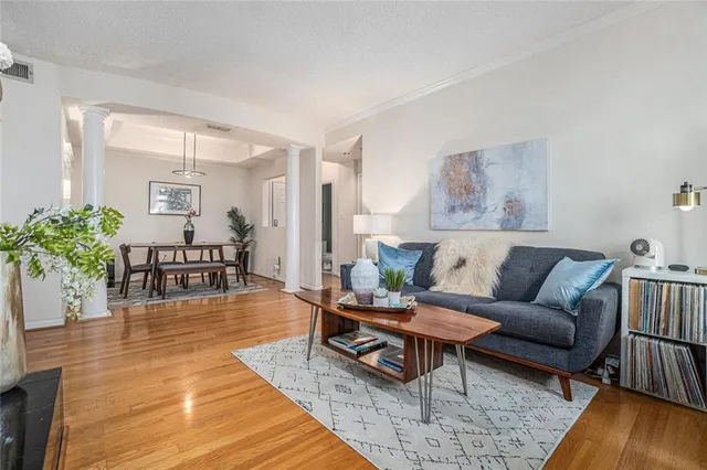 a living room with furniture and wooden floor