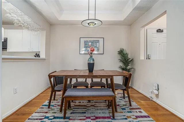 a view of a dining room with furniture wooden floor and a window