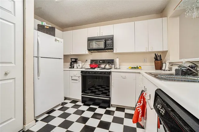 a kitchen with a refrigerator and a sink