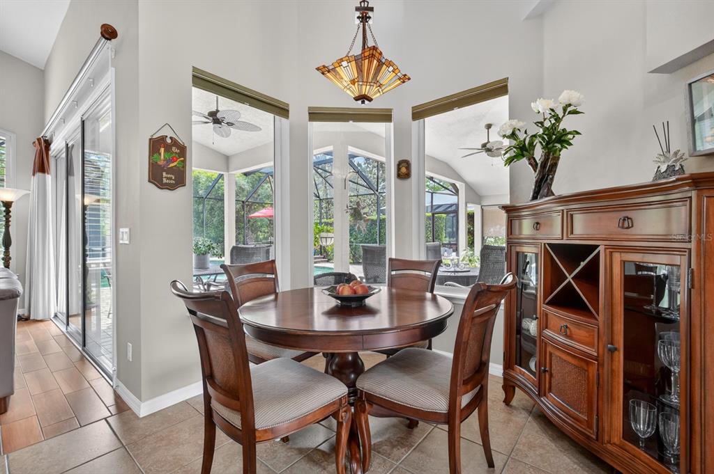 1269 Harwick Lane Ormond Beach, FL 32174 - Photo 14 of 39 a dining room with furniture potted plants and wooden floor