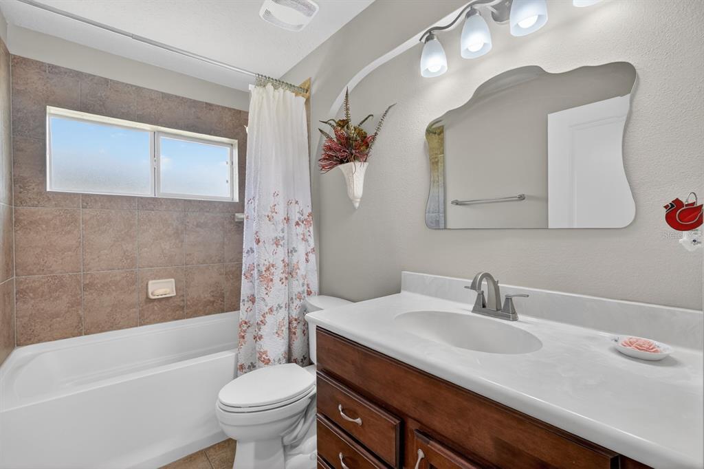 1269 Harwick Lane Ormond Beach, FL 32174 - Photo 20 of 39 a bathroom with a sink a toilet and a bathtub