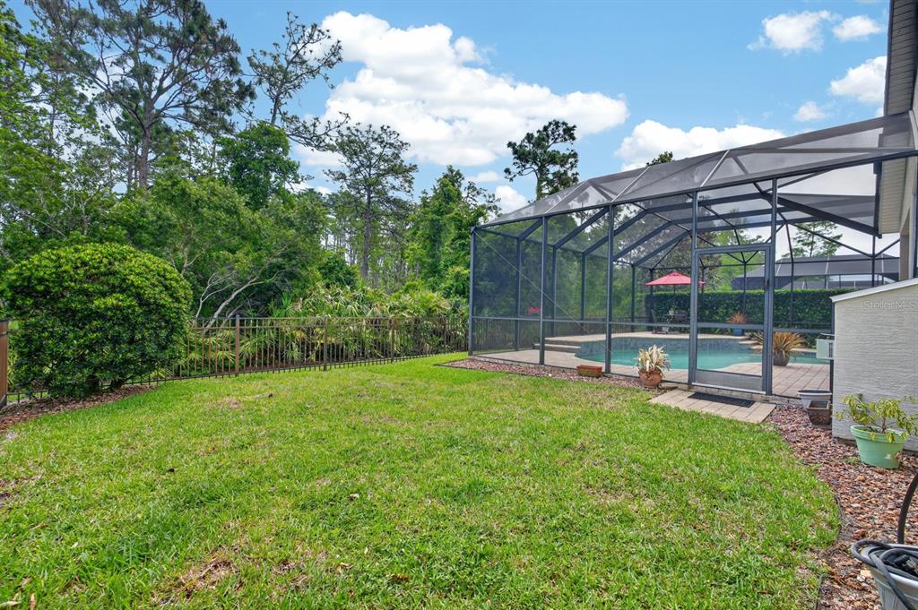 1269 Harwick Lane Ormond Beach, FL 32174 - Photo 36 of 39 a view of a chair and table in backyard of the house