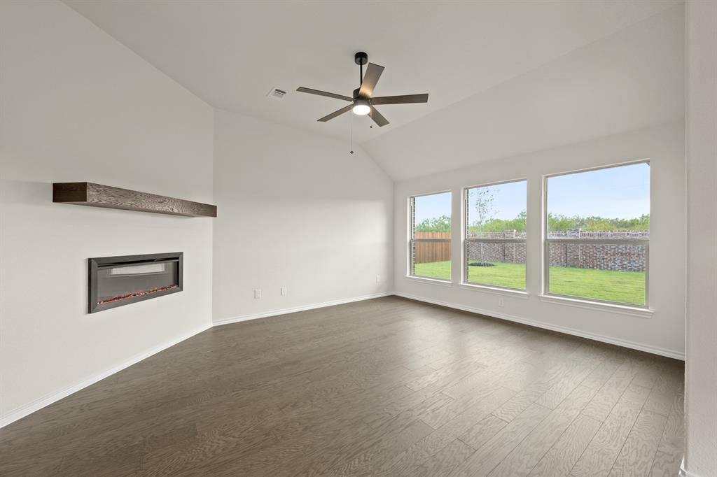 10809 Rothland Street Crowley, TX 76036 - Photo 11 of 30 a view of an empty room with a window and wooden floor