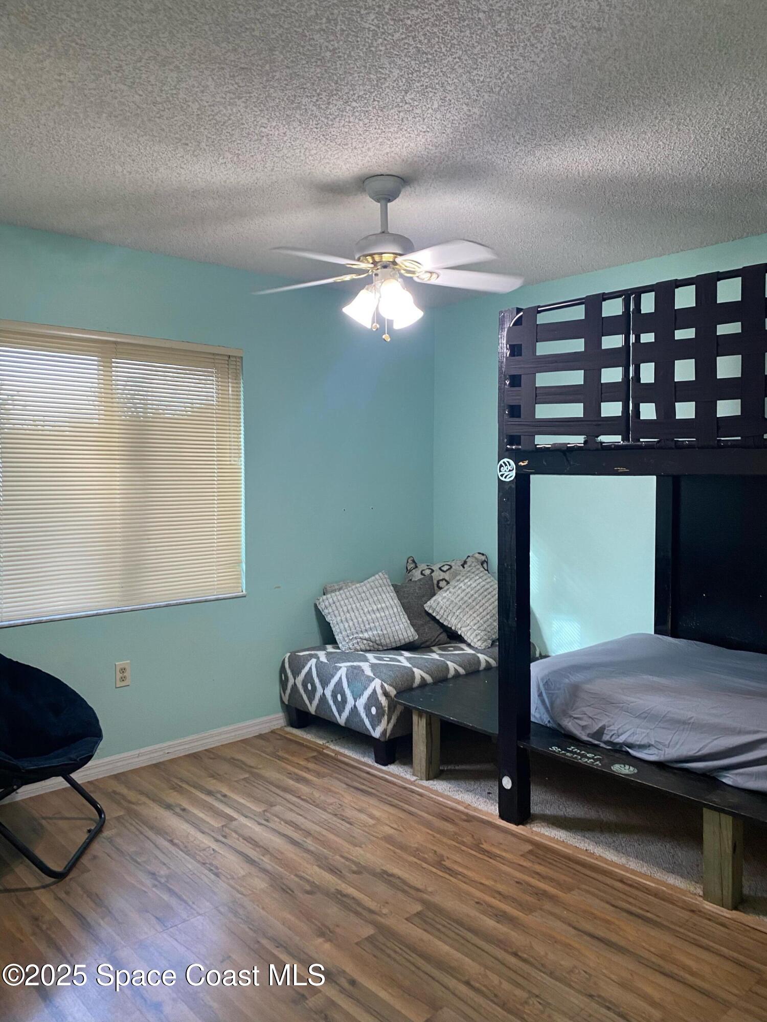 906 Black Pine Court Rockledge, FL 32955 - Photo 12 of 27 a bedroom with a bed and a table