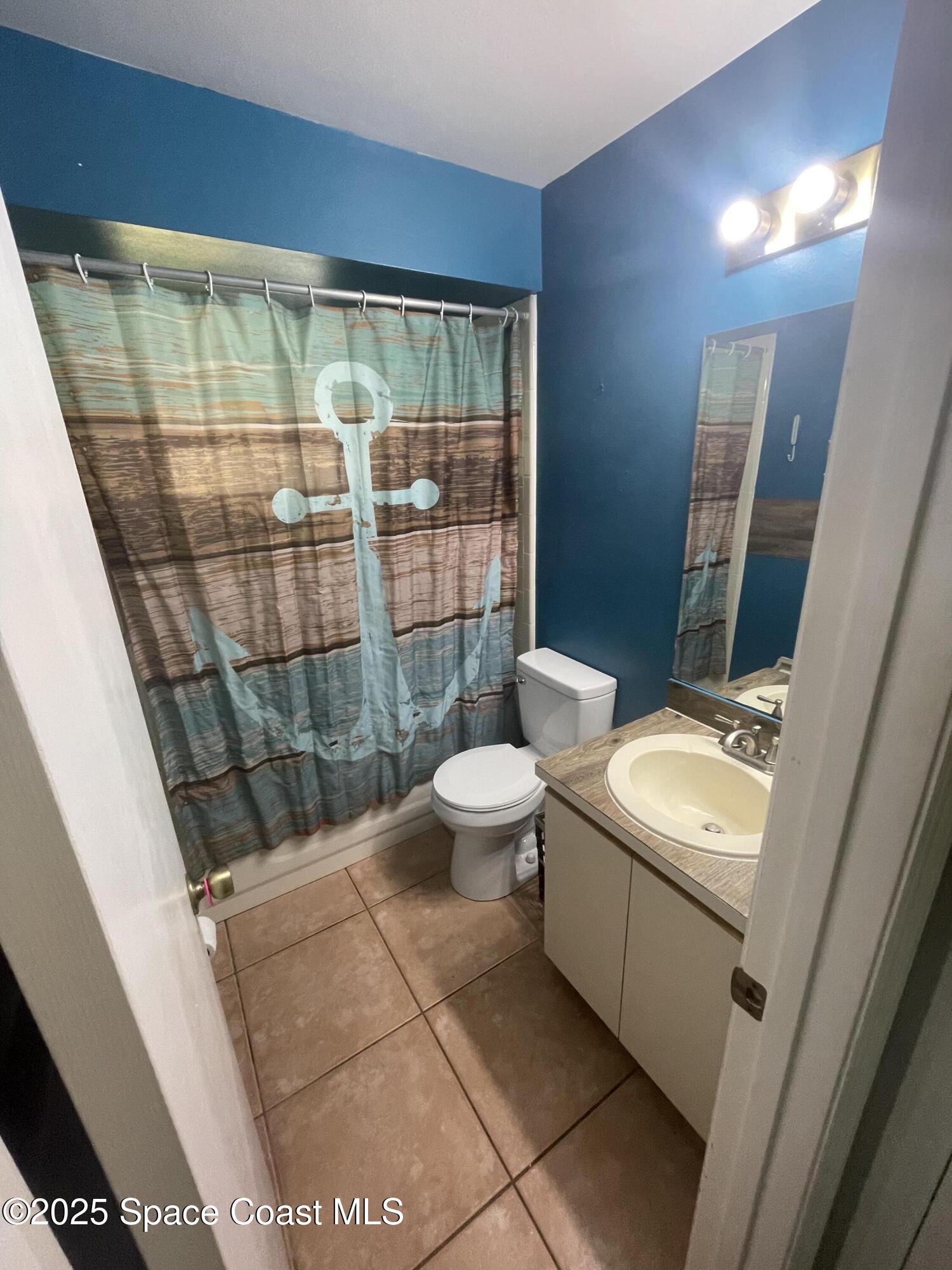 906 Black Pine Court Rockledge, FL 32955 - Photo 14 of 27 a bathroom with a sink toilet and shower