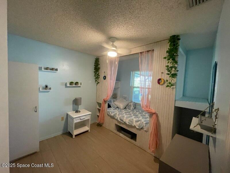 906 Black Pine Court Rockledge, FL 32955 - Photo 16 of 27 a living room with furniture and a wooden floor