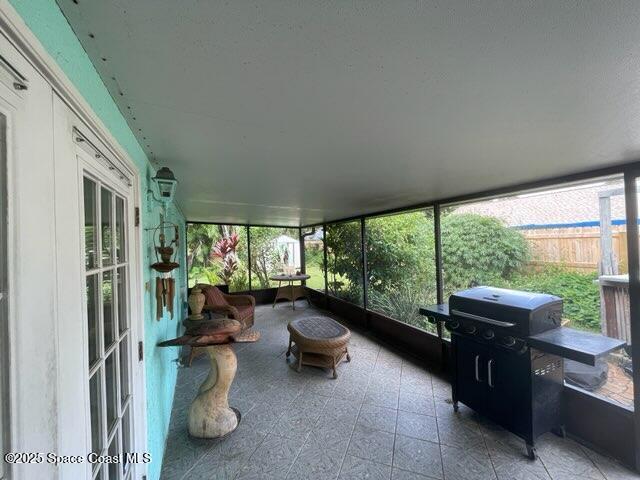 906 Black Pine Court Rockledge, FL 32955 - Photo 21 of 27 a living room with furniture and a floor to ceiling window